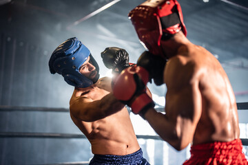 Two young professional boxer having a competition tournament on stage. 