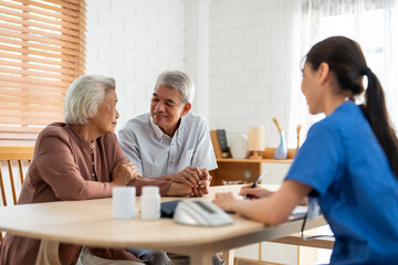 Asian caregiver nurse examine senior man and woman patient at home. 