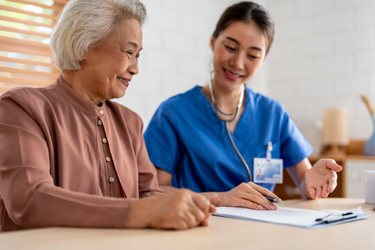 Asian young caregiver nurse examine senior woman patient at home. 