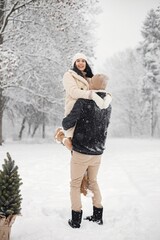 Fototapeta na wymiar Romantic couple walking in forest at winter day