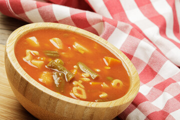 Delicious Canned Vegetable Soup on a wooden background