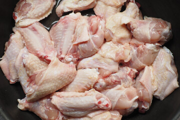 seasoning chicken on dish for cooking .