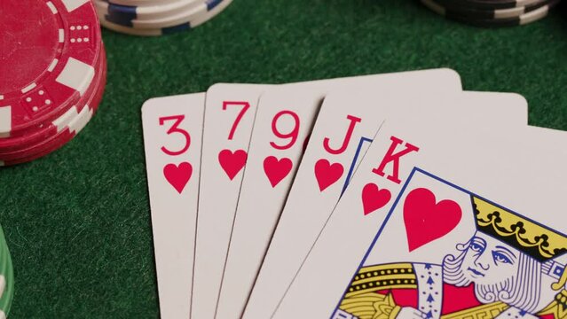 Flush poker hands on green table.