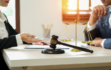 judge on wooden table And experienced lawyers meet with clients and give advice behind the scenes. legal services legal consulting concept