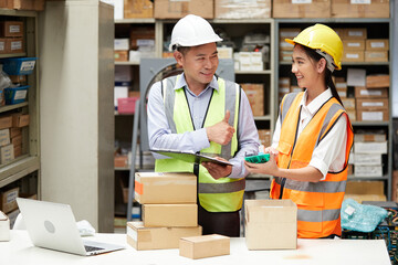 factory workers checking products from clipboard and cardboard box packaging in the warehouse storage