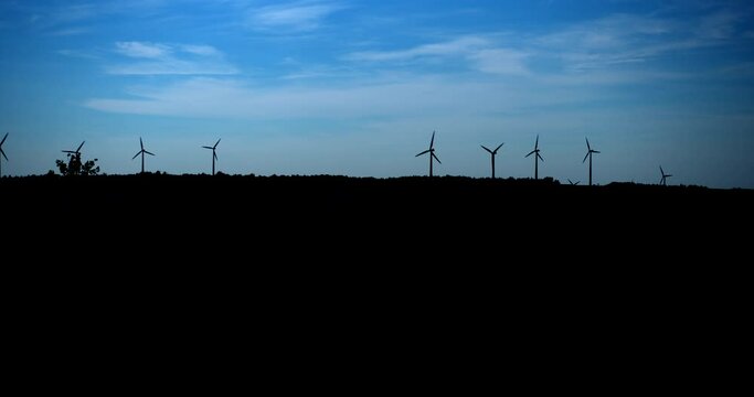 Windmill turbine silhouette / Matane / Panning to right