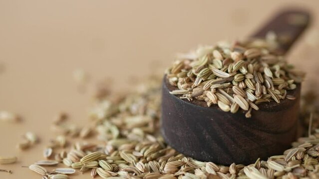 cumin seeds on spoon on table , close up 