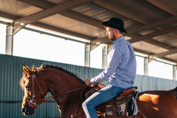 Man riding a horse in an equestrian center