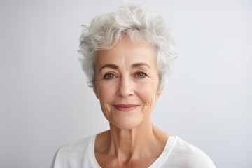 Portrait of a smiling senior woman with grey hair looking at camera
