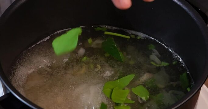 Slow Motion, Adding herbs and ingredients into clear tom yum soup, such as lemongrass, onion, kaffir lime leaves, galangal, parsley, cooking clear tom yum soup