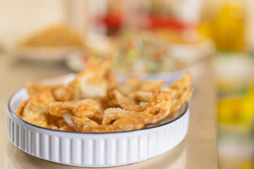 Fried wonton served in a ceramic white bowl