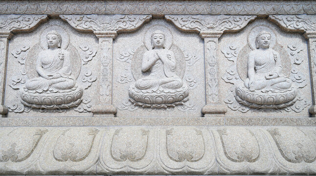 Buddha's three seated poses on stone wall reliefs at Huguo Miaochong Temple in Qingliang Mountain, photographed in Liugui Township, Kaohsiung City, Taiwan
