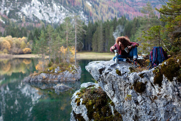 Curly Hair Caucasian Mid Adult Woman Hiker Preparing Herself an Italian Coffee Near a Lake in Mountains