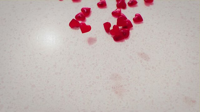 Happy Valentines Day love heart shaped sweets being dropped over text, realistic 3d animated clip.