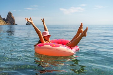 Summer vacation woman in hat floats on an inflatable donut mattress. Happy woman relaxing and enjoying family summer travel holidays travel on the sea.