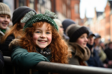 A smiling red haired girl with green clothes at the St. Patrick's Day parade in an Irish town