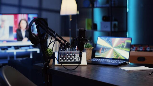 Panning shot of podcast microphone used to record discussions for internet livestreaming channel and 3D renders running on notebook screen. High tech streaming sound capturing and recording devices
