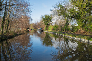 Fototapeta na wymiar Narrowboat on a British canal in rural setting