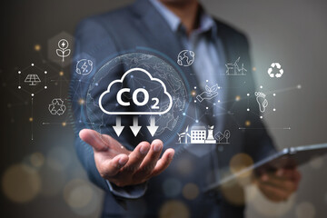 Reduce CO2 emission concept,  businessman holding CO2 emission icon concept for Sustainable development and green business renewable energy.sustainable, eco green energy system.