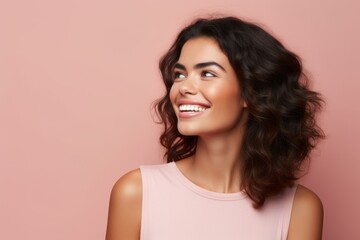 Portrait of young happy smiling beautiful brunette woman, over pink background