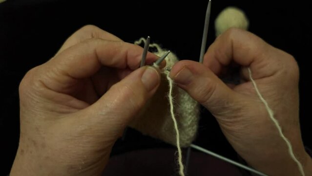 Grandmother Artisan Handcrafting Traditional Socks with Spears, Natural Sheep's Wool, Yarn Skeins
