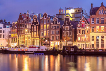 Fototapeta na wymiar Foggy morning Amsterdam canal Amstel with typical dutch houses, Holland, Netherlands.