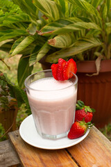 Strawberry smoothie with milk served in a glass beverage breakfast