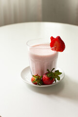 Strawberry smoothie with milk served in a glass beverage breakfast