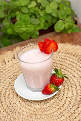 Strawberry smoothie with milk served in a glass beverage breakfast