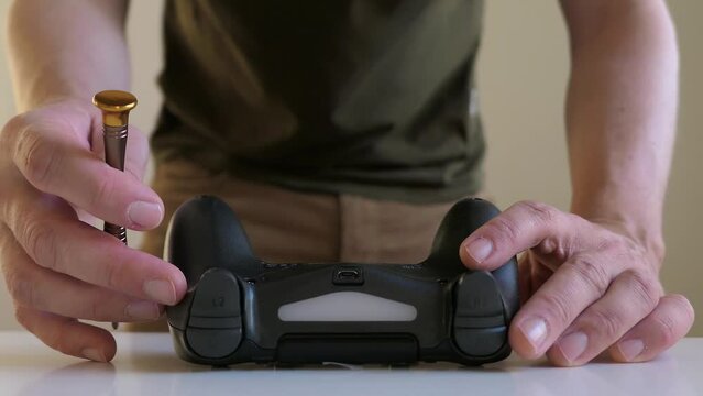Man fixing game controller, close up