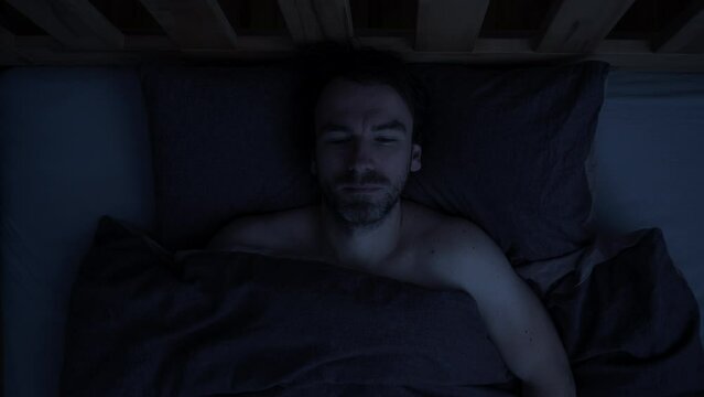 Dark of night sudden intrusion of sound disrupting the slumber of adult