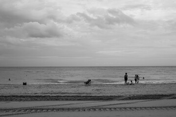 Fototapeta na wymiar People walking on the beach