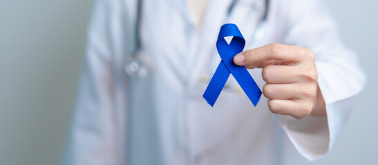 March Colorectal Cancer Awareness month, doctor with dark Blue Ribbon for supporting people living...