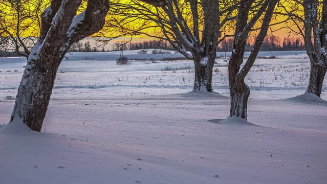 Timelapse of sunset at the horizon change the snow color to purple