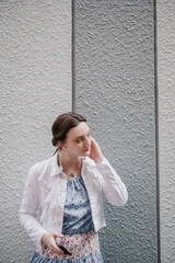 Portrait of young Caucasian Female listening to music in the city center 