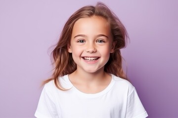 Portrait of a cute little girl with long hair on a purple background