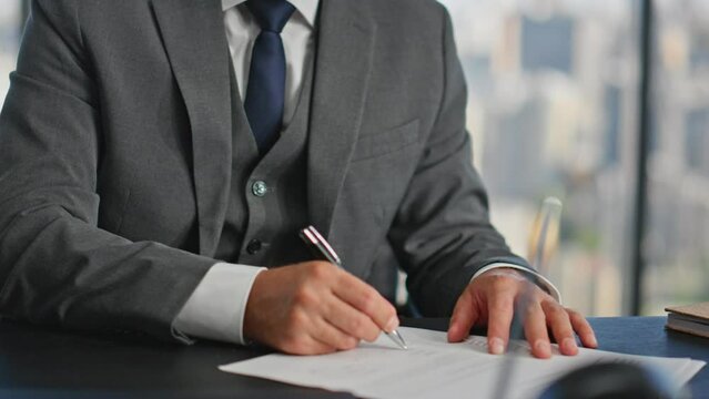 Closeup hands signing contract at desk. Confident boss thinking planning future
