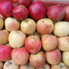 Composition of pomegranate, yellow and red apples.
Yellow red apples in the market.