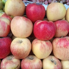 Red apples in a basket. Red and yellow apple decoration,apple background.