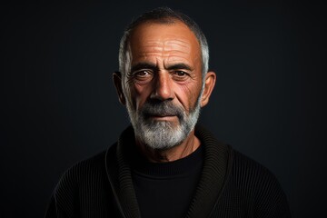 Portrait of an old man with a beard on a dark background