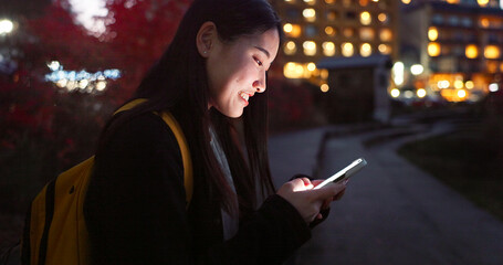 Asian woman, phone and night at city for social media, communication or outdoor networking. Female...