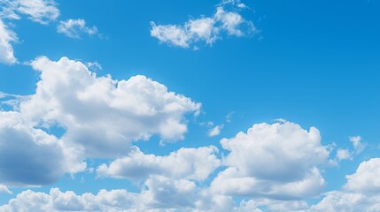Naklejka na ściany i meble Beautiful blue sky with fluffy white clouds on a sunny day