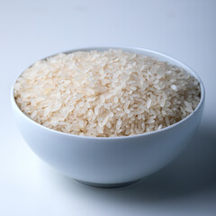 Rice in a bowl on white background. close up Selective focus.