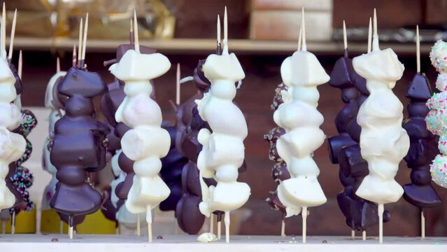 Chocolate covered fruit on a stick on display at a Christmas market stall