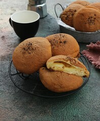 three and a half coffee loaves on an iron tray and an empty ceramic cup