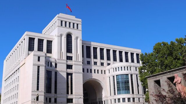 Ministry of Foreign Affairs (MFA) building in Armenia on a sunny day, featuring the Armenian flag atop, uhd, 4k, 3840, 2160