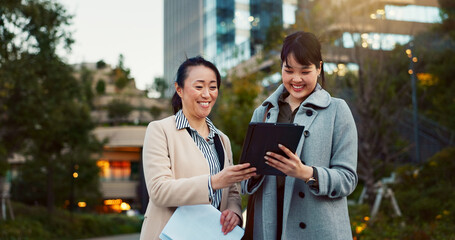 Tablet, conversation and business women in the city talking for communication or bonding. Smile,...