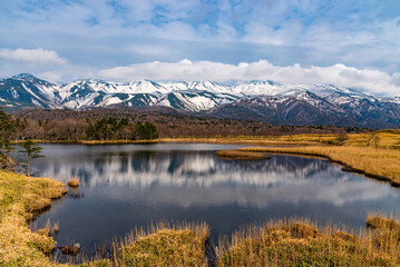 Beautiful lake and rolling mountain range on springtime sunny day. High latitude country natural...