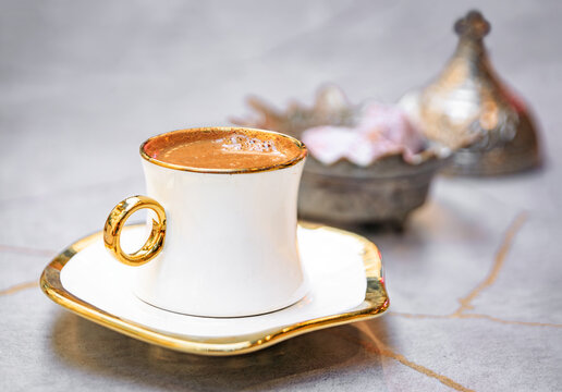 Cups of traditional Turkish coffee or turk kahvesi served with loukum or Turkish delight candy at a restaurant in Sultanahmet, Istanbul, Turkey