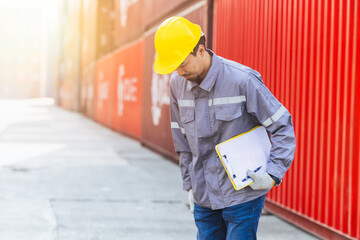 Japanese male smart worker working in container port cargo. Japan shipping logistics industry customs staff.